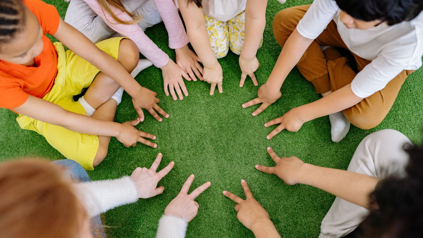 Children forming a circle with hands in community activity at Little Tree Montessori NYC